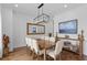 Bright dining room with a wooden table, upholstered chairs, a large mirror, and stylish decor at 5500 State Road 33, Clermont, FL 34714