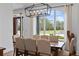 Dining room boasts a large window, modern light fixture, and neutral decor with seating for eight at 5500 State Road 33, Clermont, FL 34714