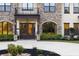 The grand entrance features stone columns, arched windows, double doors, and manicured landscaping at 5500 State Road 33, Clermont, FL 34714