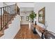 Inviting foyer with hardwood floors and a staircase leading to an upper level, creating an open and welcoming space at 5500 State Road 33, Clermont, FL 34714