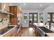 Modern kitchen features stainless steel appliances, wood cabinets, and views of the backyard pool at 5500 State Road 33, Clermont, FL 34714