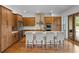 Spacious kitchen featuring custom wood cabinets, stainless steel appliances, and a large center island with seating at 5500 State Road 33, Clermont, FL 34714
