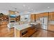 Open concept kitchen with a large island, stainless appliances, custom cabinets, flowing into the living room at 5500 State Road 33, Clermont, FL 34714