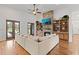 Cozy living room features a stone fireplace, custom built-ins, hardwood floors, and French doors to outdoor at 5500 State Road 33, Clermont, FL 34714