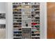 Custom shoe closet with shelving, wine cooler, and decorative items for a stylish and organized display at 5500 State Road 33, Clermont, FL 34714