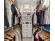 Organized walk-in closet with built-in shelving, drawers, and hanging rods for optimal storage at 5500 State Road 33, Clermont, FL 34714