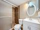 Updated bathroom featuring a glass-enclosed shower, white vanity, and neutral wall color at 562 Orange Dr # 33, Altamonte Springs, FL 32701