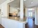 Efficient kitchen layout with white appliances, a breakfast bar, and an opening to the bedroom at 562 Orange Dr # 33, Altamonte Springs, FL 32701