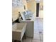 Clean laundry room featuring multiple washing machines and a utility sink at 562 Orange Dr # 33, Altamonte Springs, FL 32701