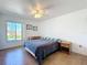 Comfortable bedroom with wood-look flooring, natural light, a desk, and neutral wall color at 562 Orange Dr # 33, Altamonte Springs, FL 32701