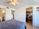 Bright bedroom featuring wood flooring, a ceiling fan, a closet, and an en-suite bathroom at 562 Orange Dr # 33, Altamonte Springs, FL 32701