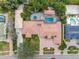 Expansive aerial view of the home, highlighting the brick driveway and backyard pool with spa at 5950 Masters Blvd, Orlando, FL 32819