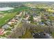 Wide aerial view of the neighborhood and community near the lake, featuring lush golf course and ponds at 5950 Masters Blvd, Orlando, FL 32819