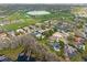 Aerial view of a golf course community showcasing waterfront homes, golf course fairways and lush landscaping at 5950 Masters Blvd, Orlando, FL 32819