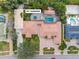 Aerial view highlighting a large home with an RV garage, pool, and beautifully designed outdoor spaces at 5950 Masters Blvd, Orlando, FL 32819