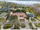 Panoramic aerial view of the property with its pool, spa, lush landscaping, and proximity to the lake at 5950 Masters Blvd, Orlando, FL 32819