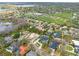 An aerial view showcases a luxury community with a golf course, waterfront access, and beautiful homes at 5950 Masters Blvd, Orlando, FL 32819