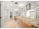Large bathroom with double sink vanity, mirror and tiled countertops at 5950 Masters Blvd, Orlando, FL 32819
