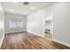 Bedroom with wood floors and natural light, open to the bathroom with a double vanity at 5950 Masters Blvd, Orlando, FL 32819