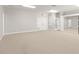 Large bonus room with neutral carpet, white walls, and several entry doors and closets at 5950 Masters Blvd, Orlando, FL 32819
