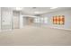 Spacious bonus room with carpeted floors, ample natural light, and mirrored closet doors at 5950 Masters Blvd, Orlando, FL 32819