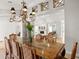 Dining room featuring travertine floors, an ornate chandelier and views into the living room at 5950 Masters Blvd, Orlando, FL 32819