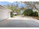 Long driveway leading to a charming home, enhanced by mature trees and well-maintained landscaping at 5950 Masters Blvd, Orlando, FL 32819
