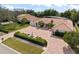 Expansive front yard with mature trees, manicured shrubs, and a brick driveway leading to the elegant home at 5950 Masters Blvd, Orlando, FL 32819