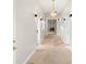 Bright hallway featuring tile flooring, decorative lighting, and doorways leading to other rooms at 5950 Masters Blvd, Orlando, FL 32819