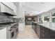 Modern kitchen with stainless steel range, granite countertops, and open layout at 5950 Masters Blvd, Orlando, FL 32819