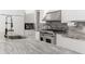 Bright kitchen with marble countertops, stainless steel appliances, and white cabinetry at 5950 Masters Blvd, Orlando, FL 32819