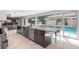 Open kitchen island boasts granite countertops and backyard pool views at 5950 Masters Blvd, Orlando, FL 32819