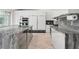Spacious kitchen featuring a large island, marble countertops, and modern appliances at 5950 Masters Blvd, Orlando, FL 32819