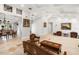 Large living room featuring travertine floors, tray ceilings, an open layout and views into the dining area at 5950 Masters Blvd, Orlando, FL 32819