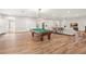 Large living room featuring a billiard table and relaxed seating arrangements at 5950 Masters Blvd, Orlando, FL 32819