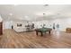 Spacious living room featuring a pool table and comfortable seating area at 5950 Masters Blvd, Orlando, FL 32819