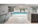 View of the backyard pool area from inside the living room, featuring tile flooring at 5950 Masters Blvd, Orlando, FL 32819