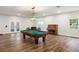 Spacious living room featuring a pool table and vintage decor at 5950 Masters Blvd, Orlando, FL 32819