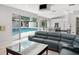 Open concept living room and kitchen featuring a view of the backyard pool at 5950 Masters Blvd, Orlando, FL 32819