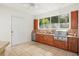 This kitchen has stainless appliances, a view window, cherry cabinets, and a ceiling fan at 5950 Masters Blvd, Orlando, FL 32819