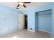 Blue bedroom with closet and plenty of natural light at 6331 Lake Lerla Dr, Apopka, FL 32712