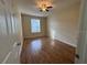Bedroom featuring wood-look floors, ceiling fan and a sunlit window at 6451 Old Park Ln # 302, Orlando, FL 32835