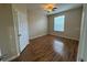 Bright bedroom featuring wood-look floors, ceiling fan and a sunlit window at 6451 Old Park Ln # 302, Orlando, FL 32835