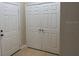 Front door and closet with paneled doors, offering a welcoming entryway at 6451 Old Park Ln # 302, Orlando, FL 32835