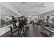 Bright gym featuring modern equipment, mirrors, and multiple ceiling fans for a comfortable workout environment at 6451 Old Park Ln # 302, Orlando, FL 32835