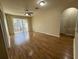 Spacious living room featuring hardwood floors, ceiling fan, and balcony access at 6451 Old Park Ln # 302, Orlando, FL 32835