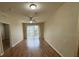 Open-concept living room with hardwood floors, ceiling fan, and sliding glass doors to balcony at 6451 Old Park Ln # 302, Orlando, FL 32835
