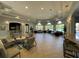 Spacious lounge area with comfortable seating, bar, and large windows offering plenty of natural light at 6451 Old Park Ln # 302, Orlando, FL 32835