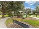 Community playground with slides and climbing equipment, surrounded by mature trees and green space at 6451 Old Park Ln # 302, Orlando, FL 32835