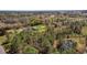 Aerial view of a single-Gathering home with a large lot and wooded surroundings, providing privacy and natural beauty at 7322 Groveland Farms Rd, Groveland, FL 34736
